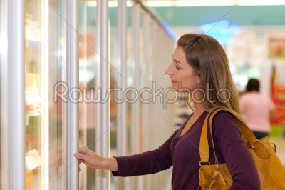 Woman in supermarket freezer section