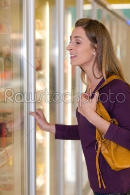 Woman in supermarket freezer section