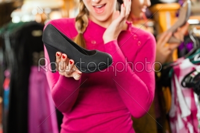 Woman is buying shoes for her Tracht or dirndl in a shop