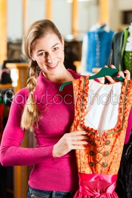 Woman is buying Tracht or dirndl in a shop
