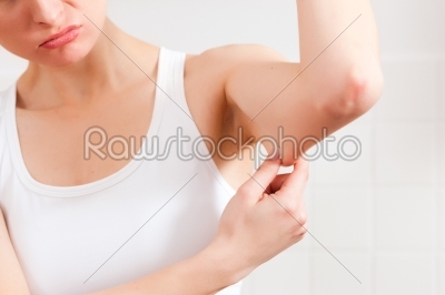 Woman is checking her triceps
