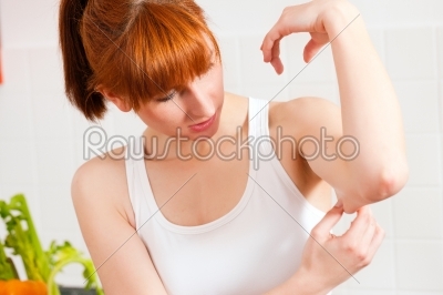 Woman is checking her triceps