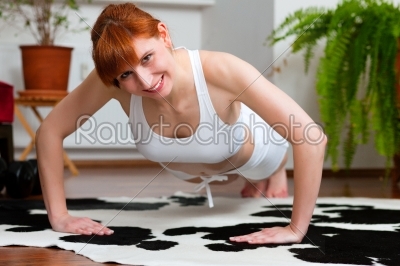 Woman is exercising at home