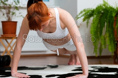 Woman is exercising at home