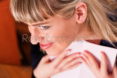 Woman is holding a letter