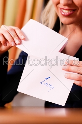 Woman is holding a love letter