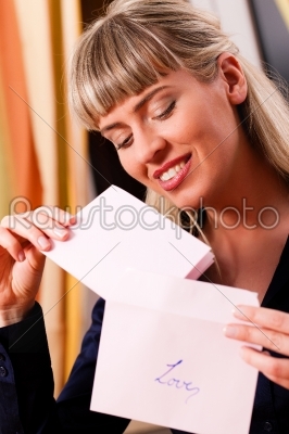 Woman is holding a love letter