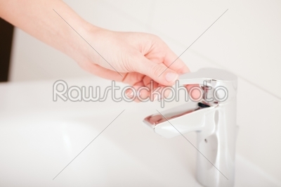 Woman (just hands) turns of tap 