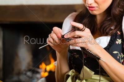 woman knitting in hunter_qt_s cabin or alpine hut