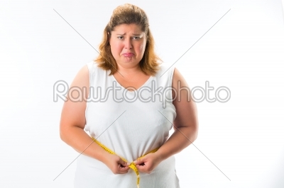 Woman measuring her waist with tape