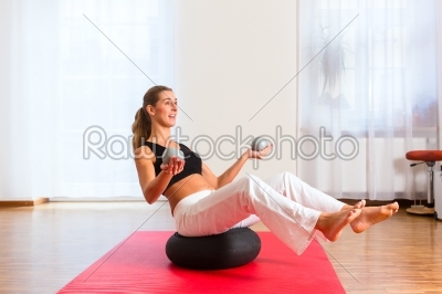 woman practicing poses on exercise ball