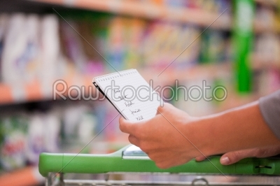 Woman Shopping with Checklist and Trolley