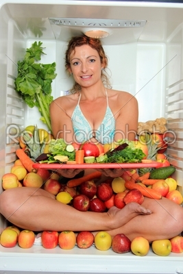 Woman sitting in a fridge