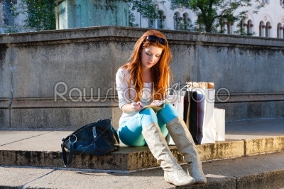 Woman sitting in front of fountain