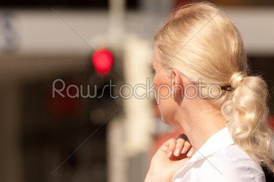 Woman standing at red traffic light