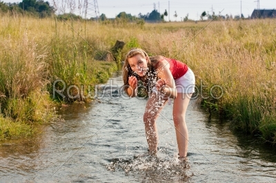 Woman standing in creek summer