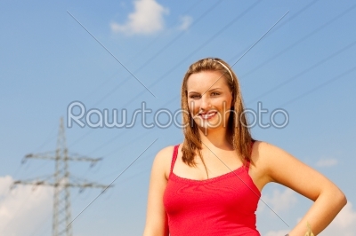 Woman standing in front of power pole