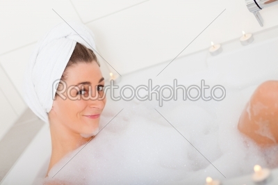 Woman takes bubble foam bath