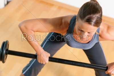 Woman with barbell in gym