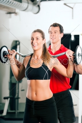 Woman with Personal Trainer in gym