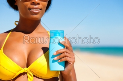 Woman with suncream at the beach
