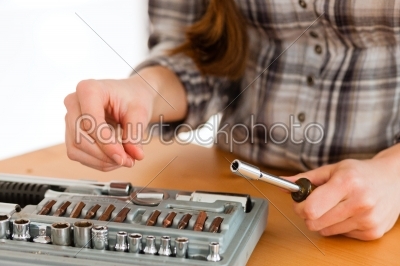 Woman with toolbox and screwdriver