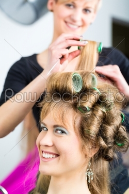 Women at the hairdresser being curled