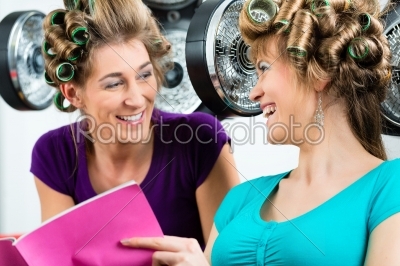Women at the hairdresser with hair dryer