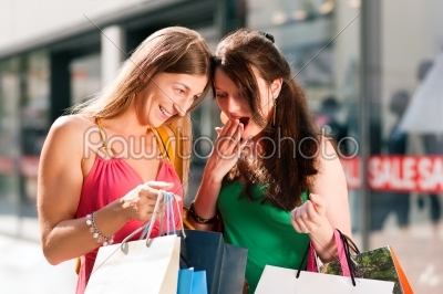 women downtown shopping with bags