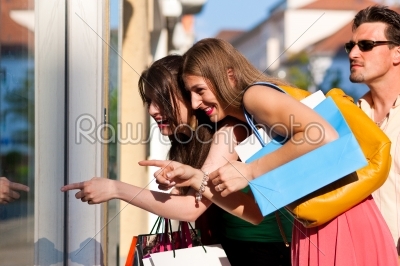 Women downtown shopping with bags
