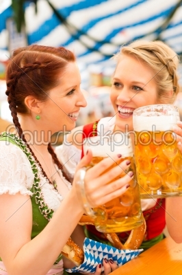 Women with traditional Bavarian dirndl in beer tent