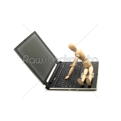 wood mannequin and laptop