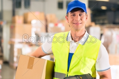 worker holds package in warehouse of forwarding