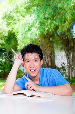 Young Chinese Boy with homework for school