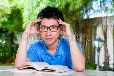 Young Chinese Boy with homework for school