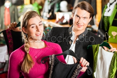 Young couple is buying Tracht or dirndl in a shop