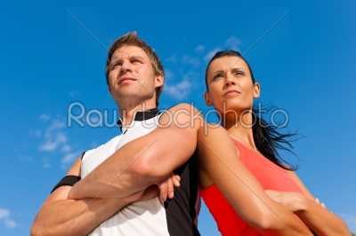 Young couple is doing sports outdoors