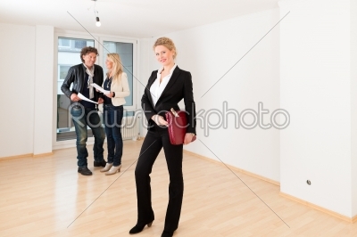 Young couple looking for real estate with female realtor	
