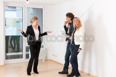 Young couple looking for real estate with female realtor