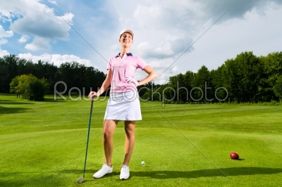 Young female golf player on course