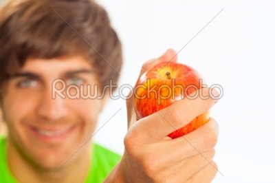 Young man holding an apple