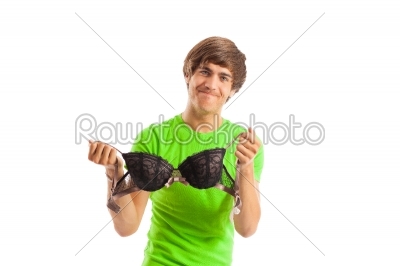 Young man with bra in studio