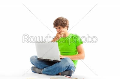 Young man with laptop and legs crossed