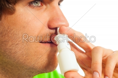 Young man with nasal spray