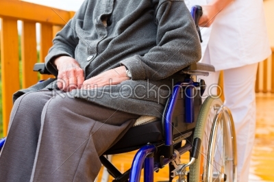 Young nurse and female senior in a wheel chair