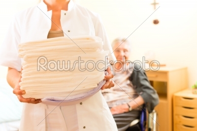 Young nurse and female senior in nursing home