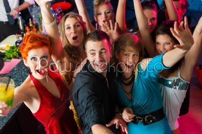 Young people dancing in club or disco, men and women