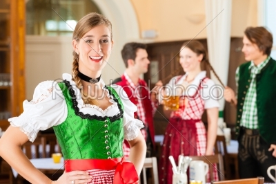 Young people in traditional Bavarian Tracht in restaurant or pub