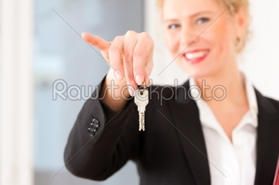 Young realtor is with keys in an apartment