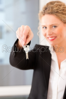 Young realtor is with keys in an apartment